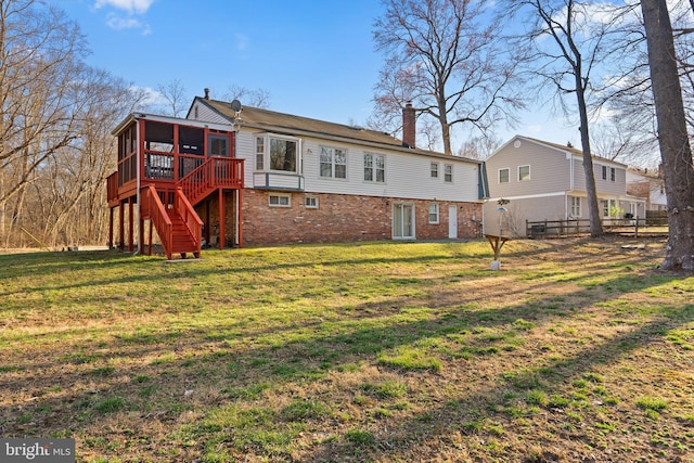 back of house featuring stairway, fence, a yard, a sunroom, and a chimney