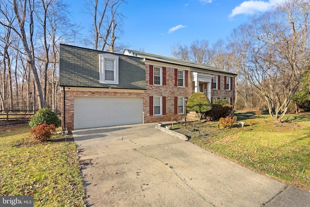 raised ranch with mansard roof, concrete driveway, a front yard, an attached garage, and brick siding