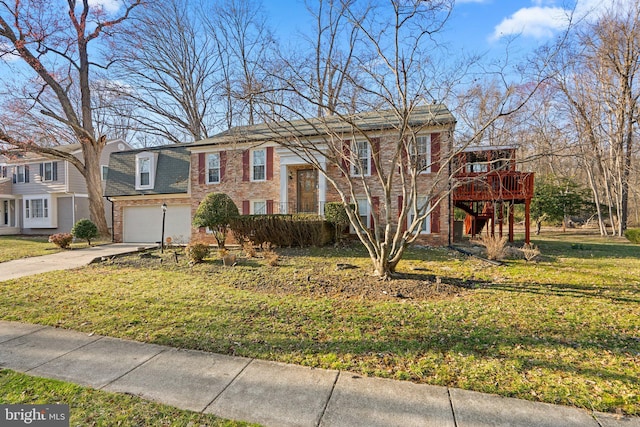 bi-level home with a wooden deck, a front yard, brick siding, and driveway