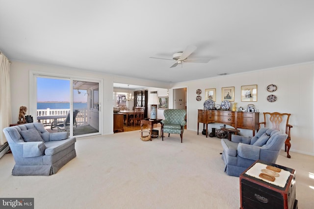 carpeted living room featuring a ceiling fan