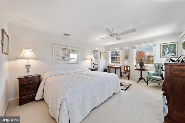 bedroom with visible vents, light colored carpet, crown molding, and baseboards