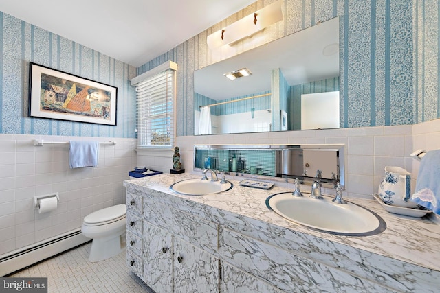 bathroom featuring wallpapered walls, a shower with curtain, baseboard heating, and a sink