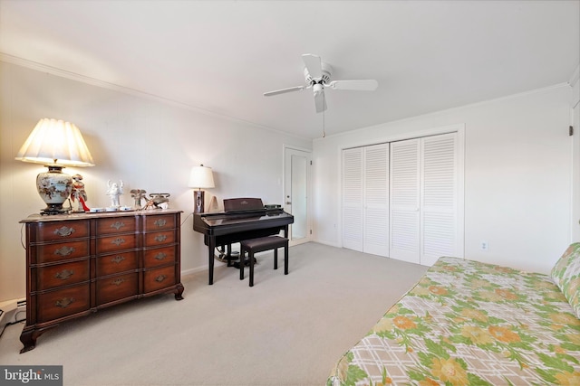 bedroom featuring a closet, light colored carpet, and crown molding