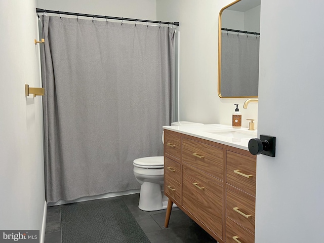 bathroom featuring vanity, toilet, and tile patterned flooring