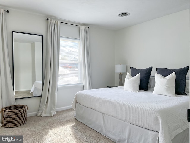 bedroom with visible vents, baseboards, and carpet