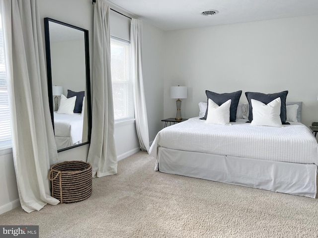 carpeted bedroom with baseboards