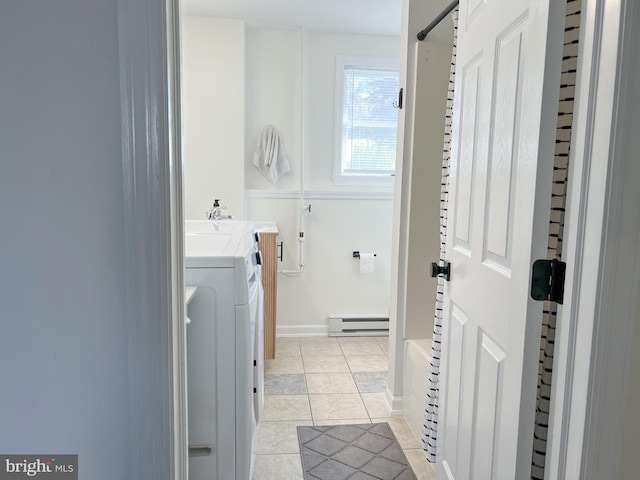 laundry area featuring light tile patterned floors, baseboards, washing machine and clothes dryer, laundry area, and baseboard heating