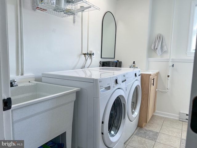 laundry room featuring a sink, light tile patterned flooring, laundry area, and washing machine and clothes dryer