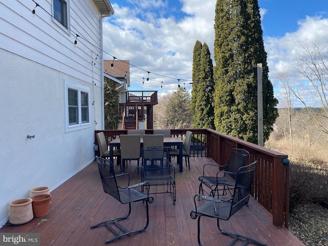 wooden terrace featuring outdoor dining space