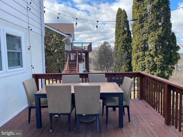 deck featuring stairway and outdoor dining space