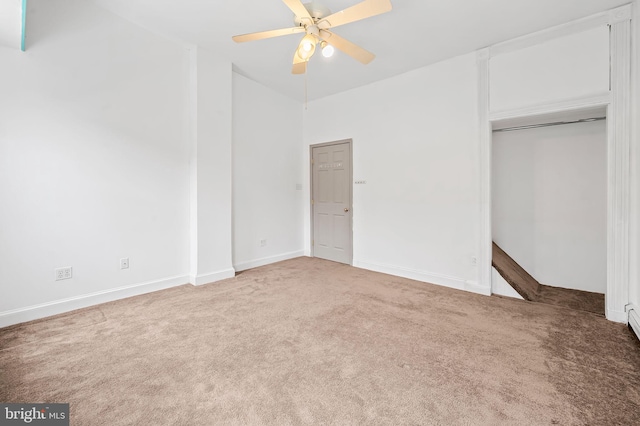 unfurnished bedroom with a closet, ceiling fan, baseboards, and carpet