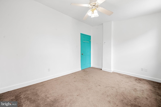 unfurnished room featuring carpet flooring, a ceiling fan, and baseboards