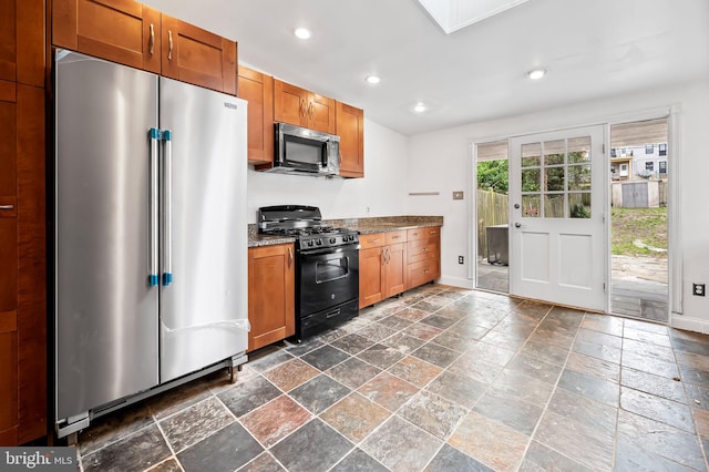 kitchen featuring recessed lighting, baseboards, appliances with stainless steel finishes, and brown cabinets