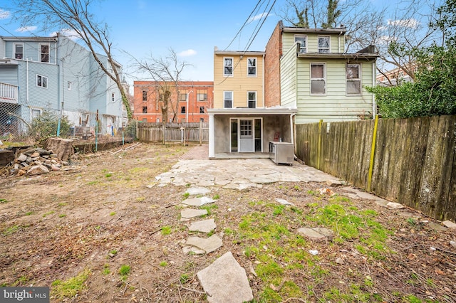 back of house with a patio area and a fenced backyard