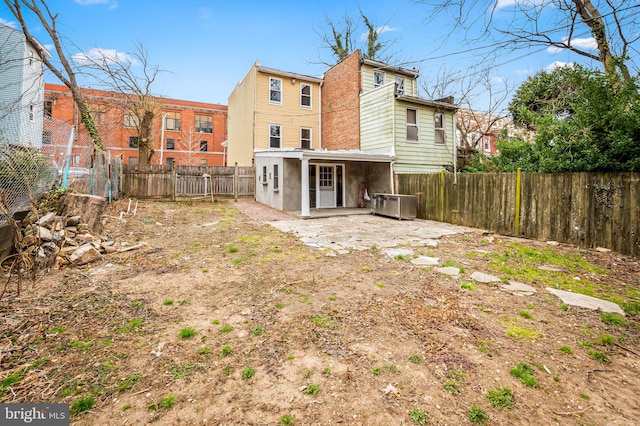 back of property featuring a patio area and a fenced backyard