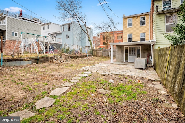 view of yard featuring a patio area, a fenced backyard, and a residential view