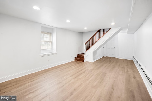 interior space featuring stairway, baseboards, a baseboard radiator, light wood-style flooring, and recessed lighting