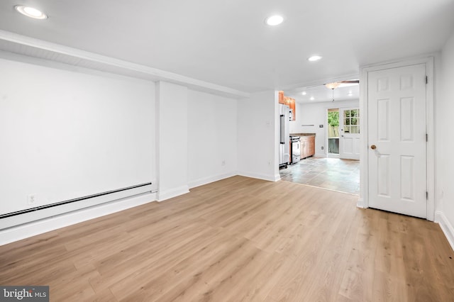 unfurnished living room featuring baseboard heating, recessed lighting, baseboards, and light wood finished floors