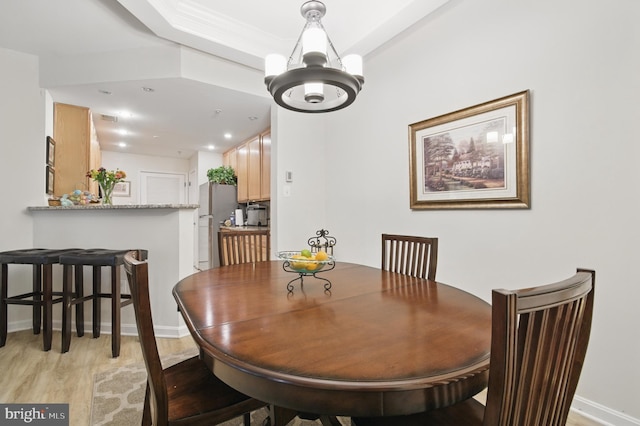 dining area featuring baseboards, recessed lighting, light wood finished floors, and a chandelier