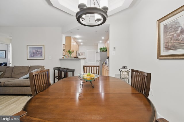 dining area featuring a chandelier and wood finished floors