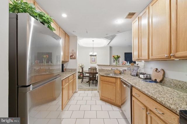 kitchen featuring visible vents, appliances with stainless steel finishes, light stone counters, a peninsula, and light tile patterned flooring