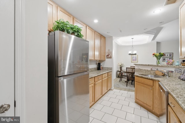 kitchen with light tile patterned flooring, a sink, light brown cabinets, stainless steel appliances, and visible vents