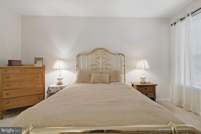 carpeted bedroom featuring baseboards
