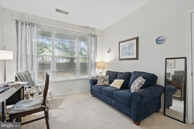 carpeted living area featuring baseboards and visible vents