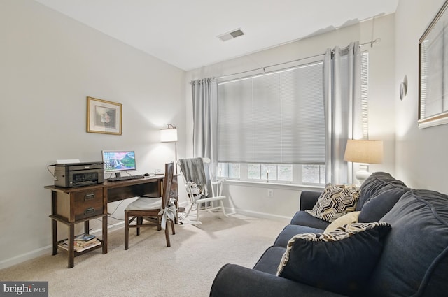 office space with baseboards, carpet flooring, and visible vents