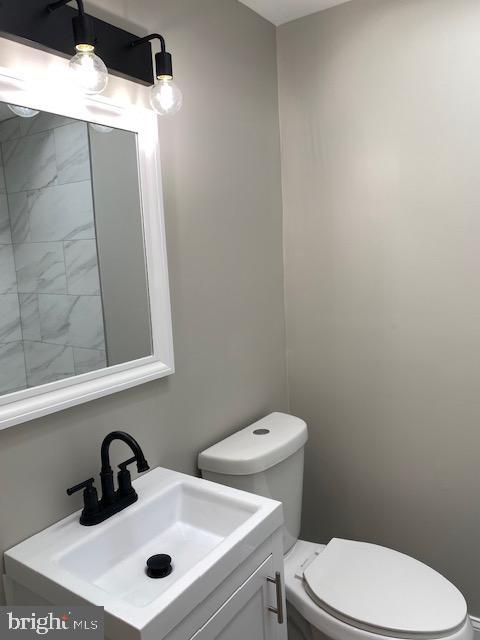 bathroom featuring toilet and vanity