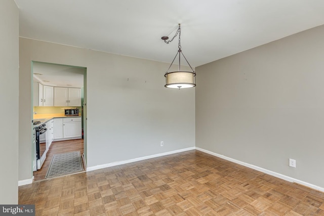 unfurnished dining area featuring baseboards