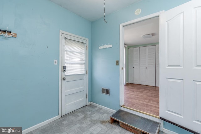 interior space with tile patterned floors, visible vents, and baseboards