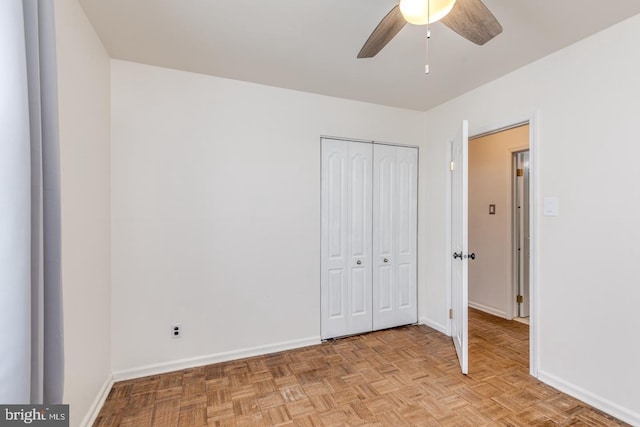 unfurnished bedroom featuring a closet, baseboards, and ceiling fan