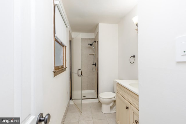 full bathroom with vanity, toilet, a shower stall, and tile patterned flooring