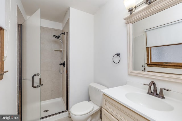 full bathroom with toilet, a stall shower, and vanity