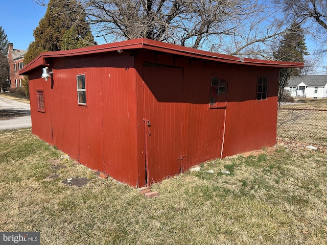 view of outdoor structure with an outbuilding and fence