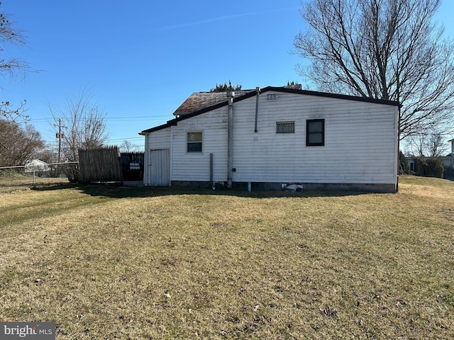 view of home's exterior featuring a yard and fence