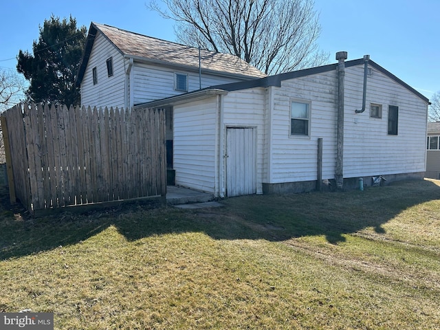 view of outbuilding with fence