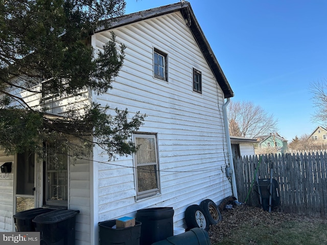 view of side of property featuring fence