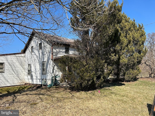 view of property exterior with a yard