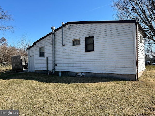 view of side of property with a yard and fence