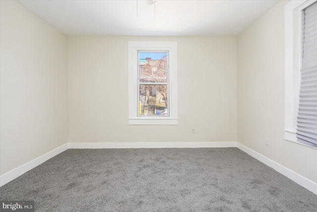 empty room with baseboards and carpet floors