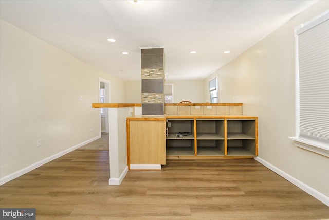 interior space featuring light wood finished floors, recessed lighting, and baseboards