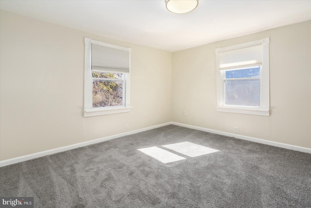 spare room with carpet flooring and baseboards