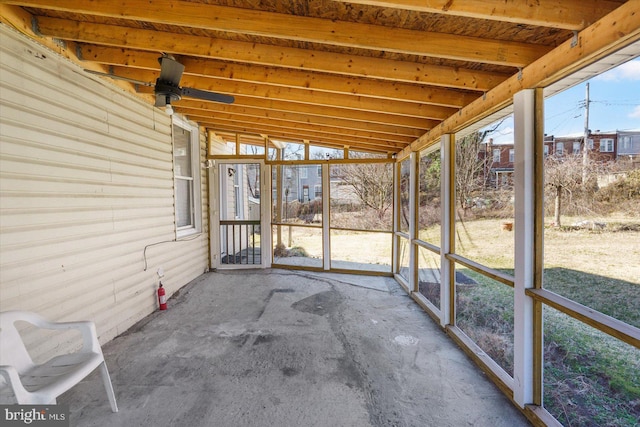 unfurnished sunroom with lofted ceiling and ceiling fan