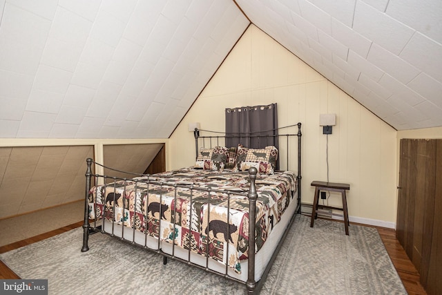 bedroom featuring lofted ceiling and wood finished floors