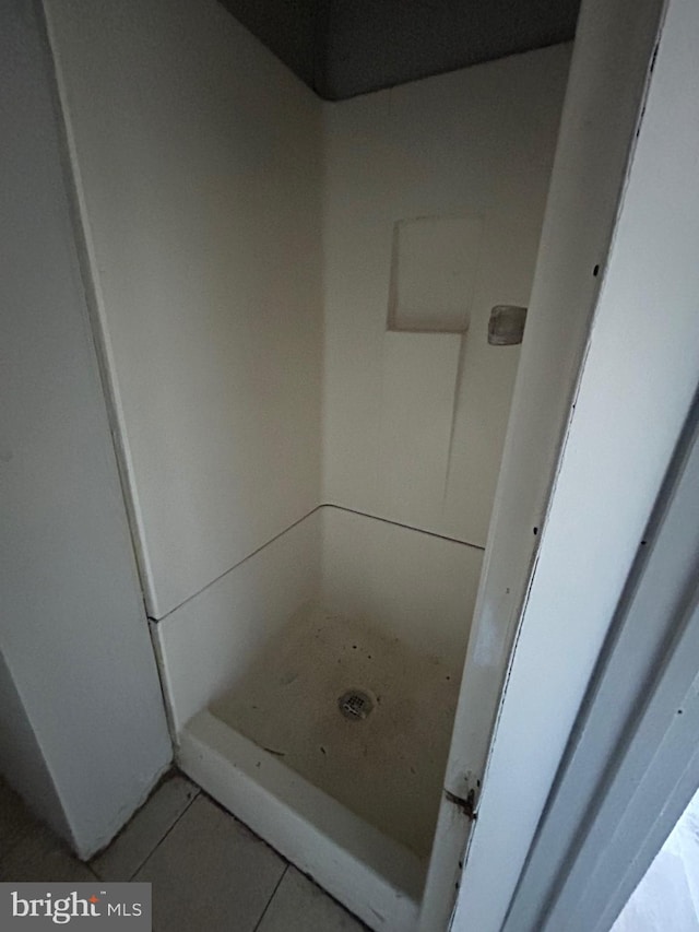 bathroom featuring tile patterned flooring and a stall shower