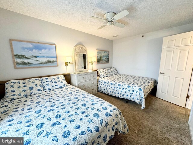 bedroom with visible vents, ceiling fan, a textured ceiling, and carpet