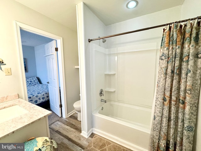 full bath with vanity, toilet, wood finished floors, and shower / bath combo with shower curtain