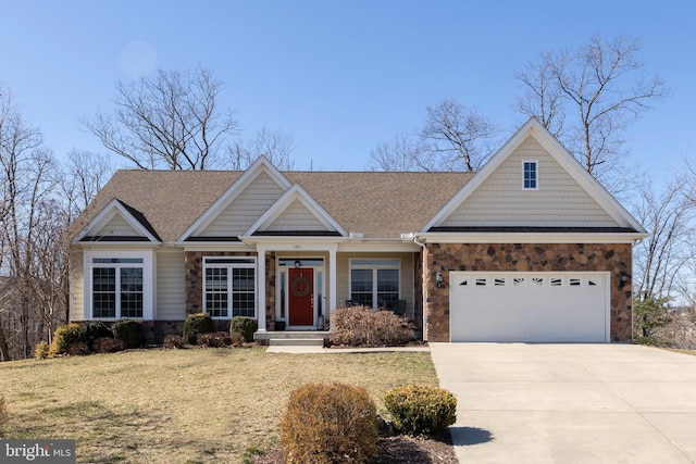 craftsman-style home with a shingled roof, concrete driveway, a front yard, stone siding, and an attached garage